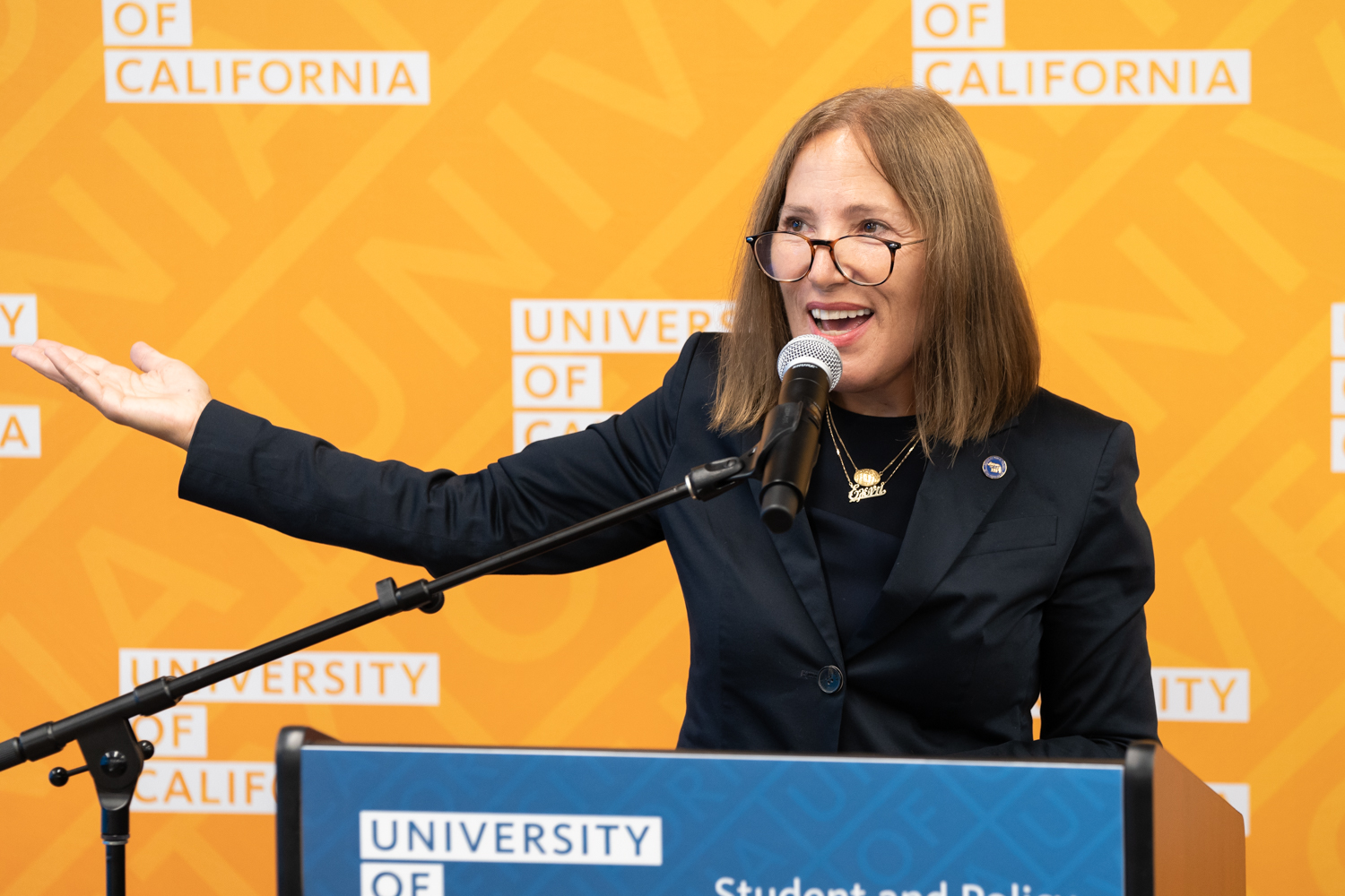 Lt. Gov Kounalakis at a lectern, wearing glasses