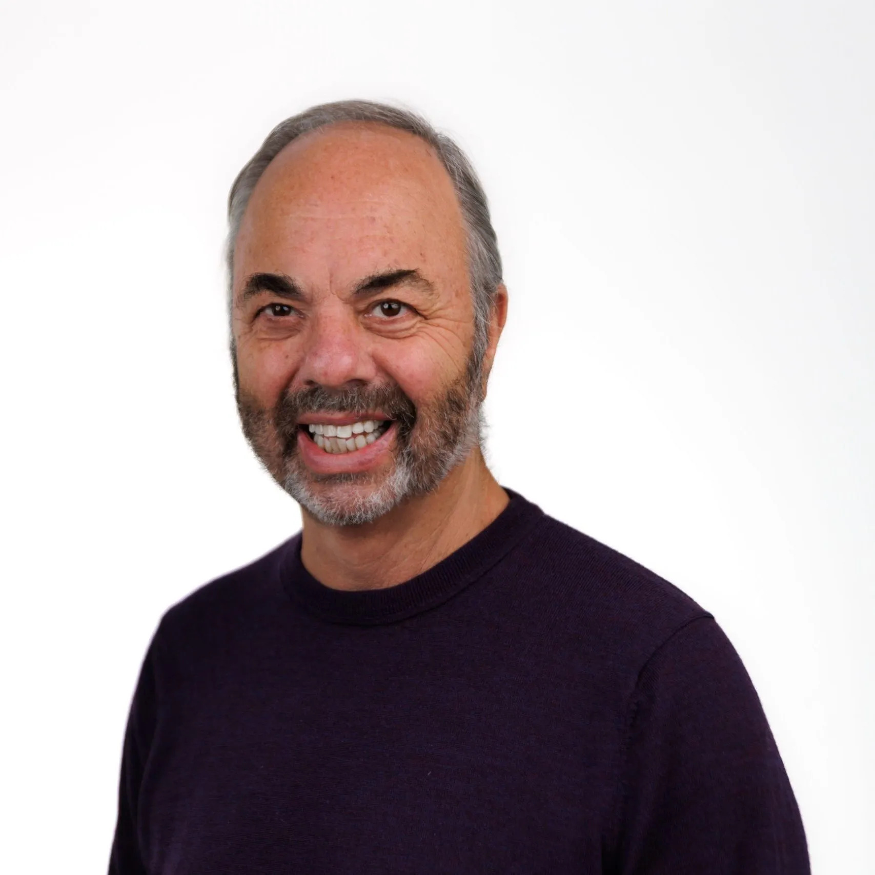 Ken Doctor, white man with beard and a black sweater, smiling