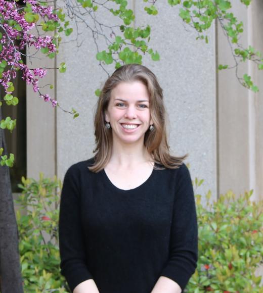 Christine Diepenbrock smiles for a portrait in a courtyard