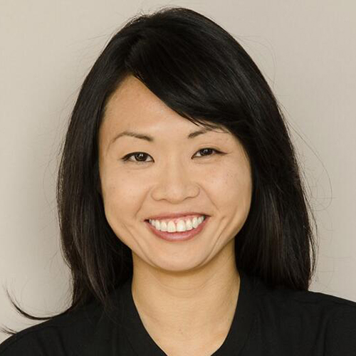 Winnie Wong smiles for a headshot against a neutral background