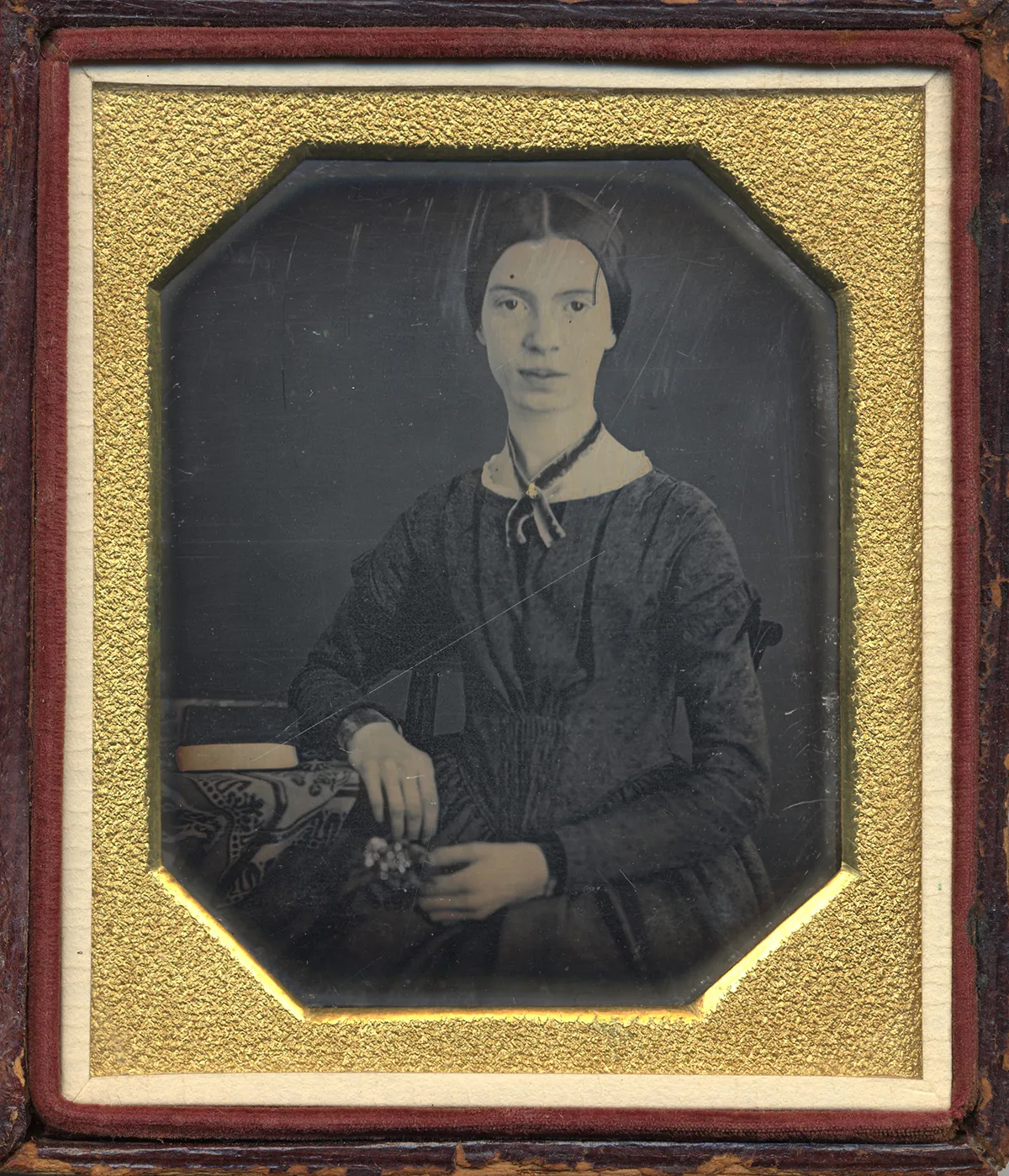 a vintage black and white portrait of Emily Dickinson in a wood and gold frame