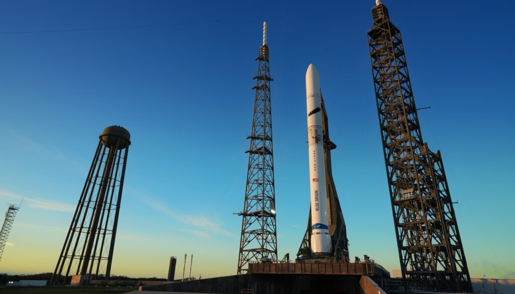 A white rocket on a launchpad at dawn