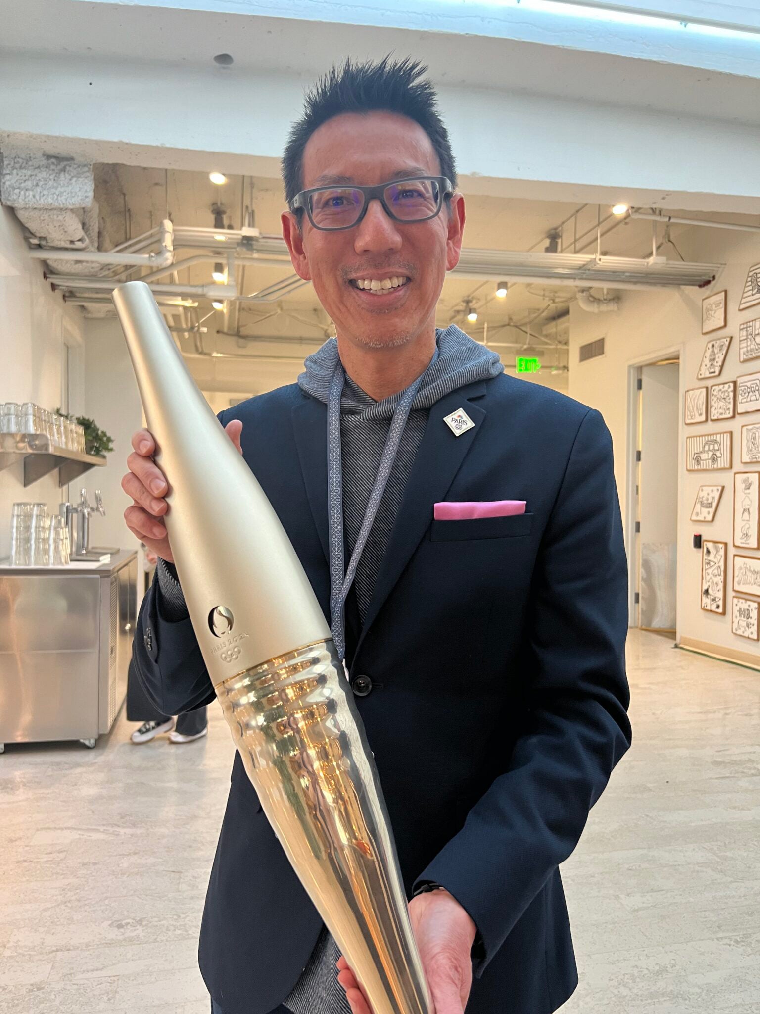 A man holds a gold-colored object