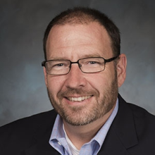 A man with glasses and a beard