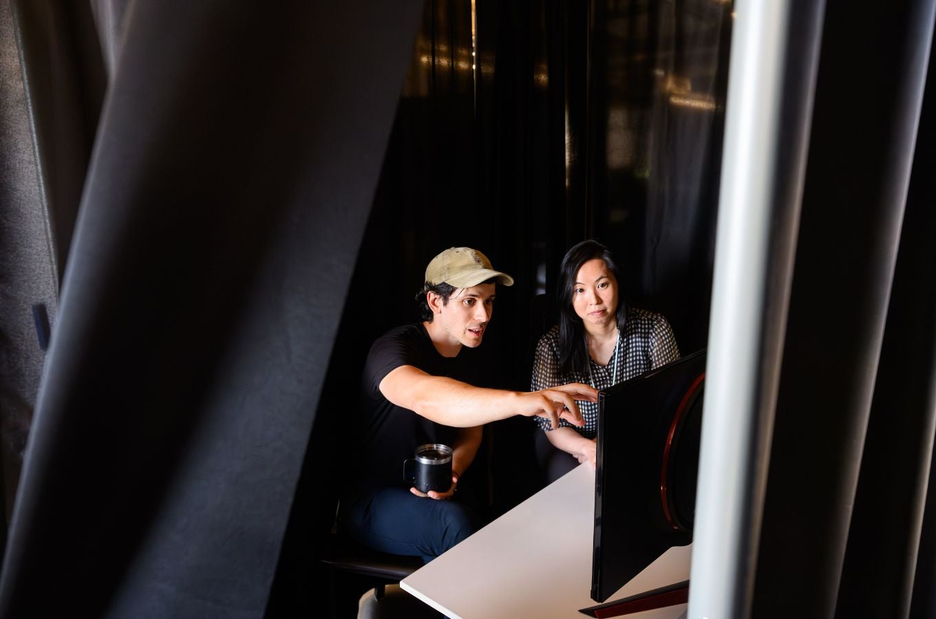 Researchers Adam Yala and Maggie Chung discuss while looking at a computer screen