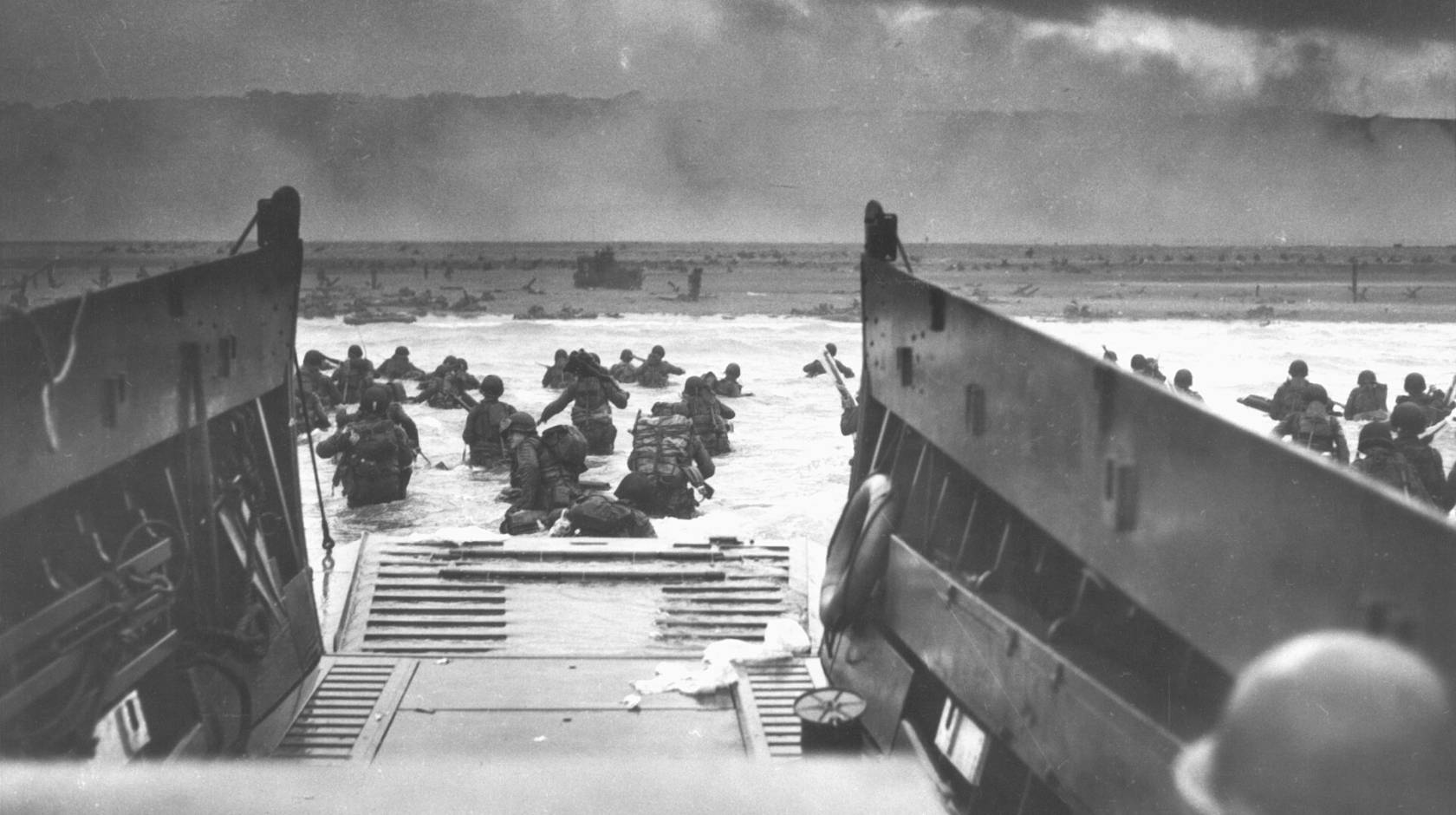 Photographed from inside a landing vessel, the U.S. Army wades ashore on D-Day, June 6, 1944