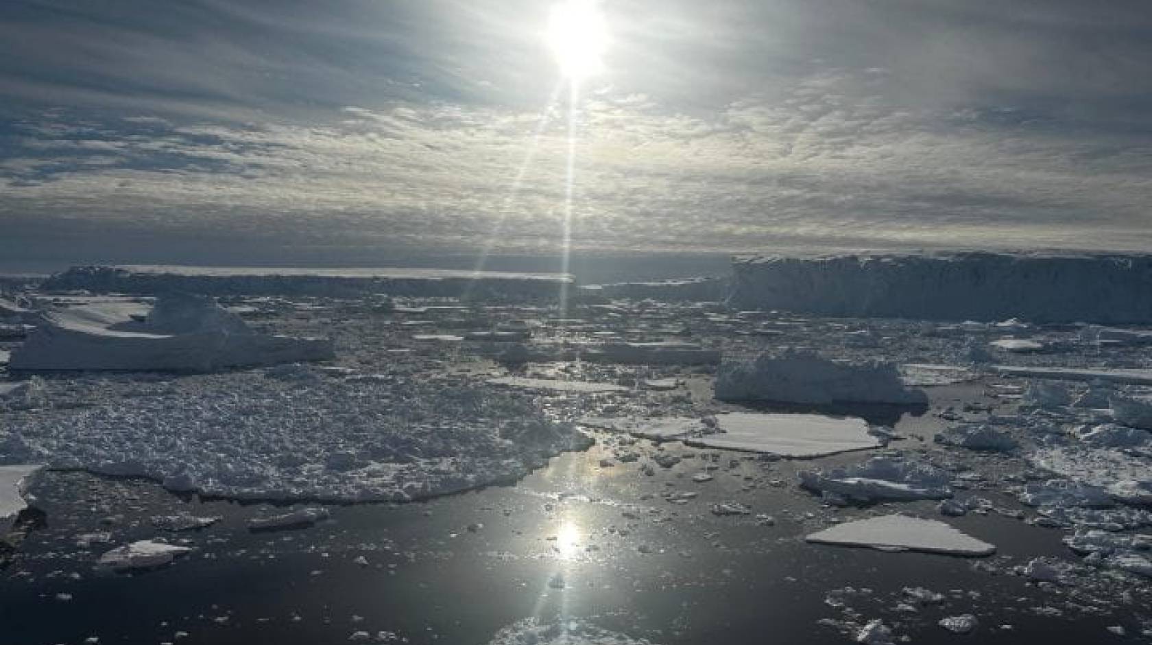 The sun glances off a sheet of ice