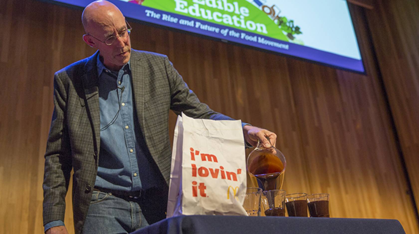 Michael Pollan makes a point about the amount of oil it takes to produce a hamburger during an Edible Education lecture at UC Berkeley.