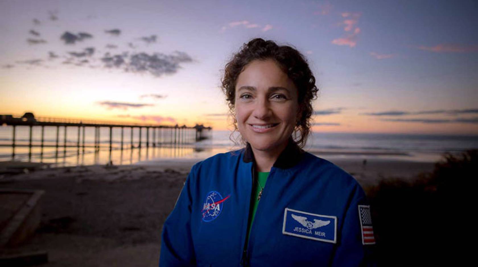 Jessica Meir in front of a pier in San Diego at sunset