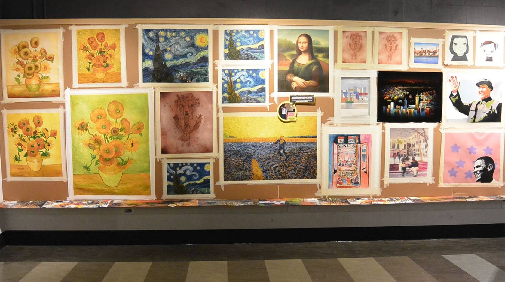 A museum gallery wall showing several versions of iconic paintings, including the Mona Lisa and Starry Night