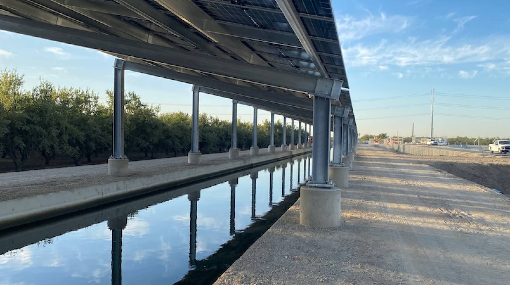 Solar panels over a canal near a highway
