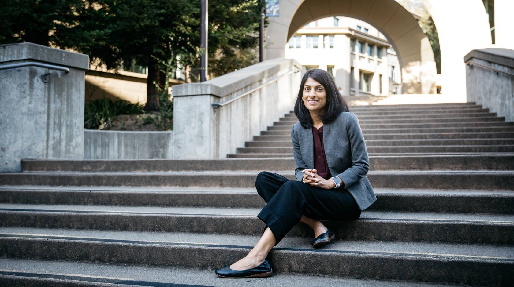 A professor sits on stairs on the UC Berkeley campus