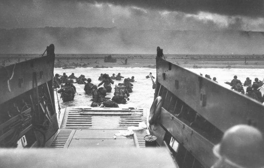 Photographed from inside a landing vessel, the U.S. Army wades ashore on D-Day, June 6, 1944