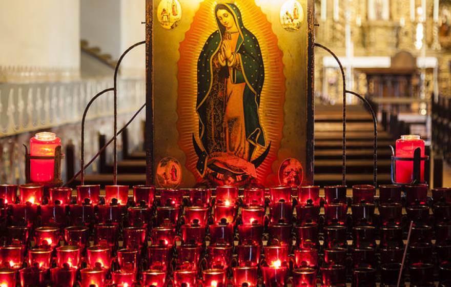 Lit candles inside a California mission