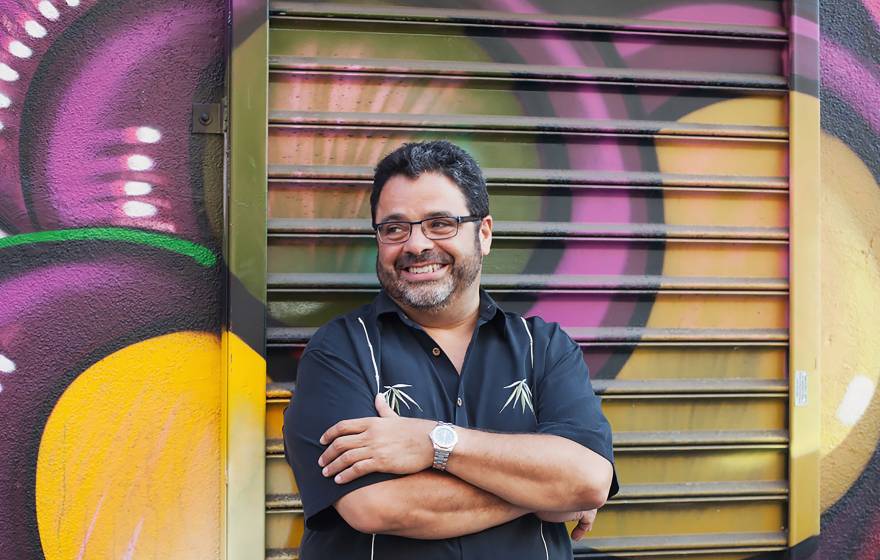 Arturo O’Farrill in front of a mural