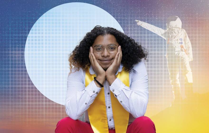 A young man with shoulder-length hair on his shoulders, wearing a stole, smiles at the camera propping up his chin, with the background bearing a gradient illustration of an astronaut pointing at the moon