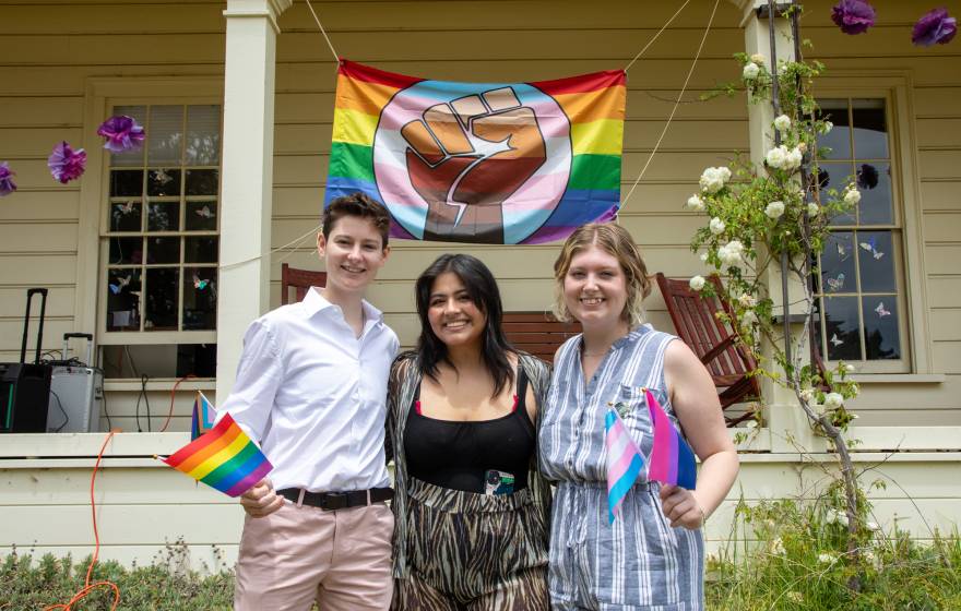 Three people in front of Lionel Cantú Queer Resource Center porch