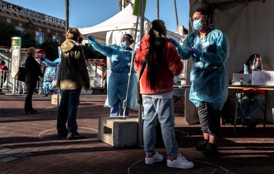 Mission residents are swabbed for COVID-19 at a pop-up, test site at the 24th St. Mission Bart Station