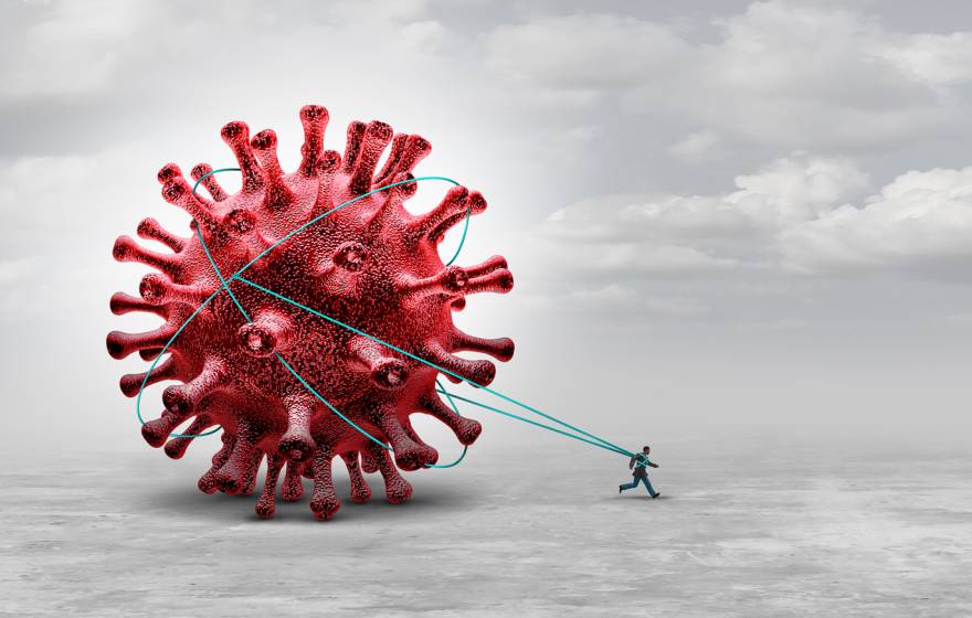 A man pulling a giant COVID molecule