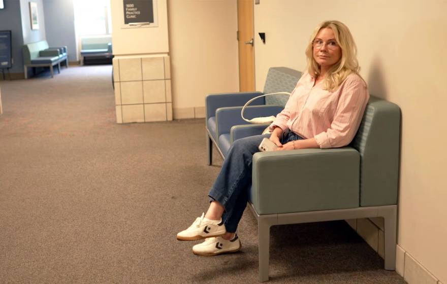 A woman waits expectantly in a hallway