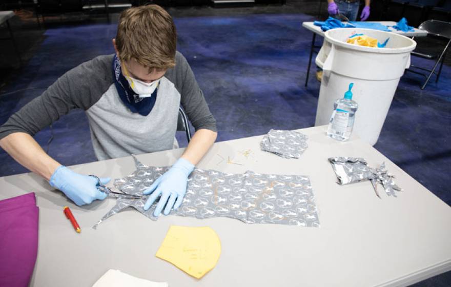 Young man sewing masks