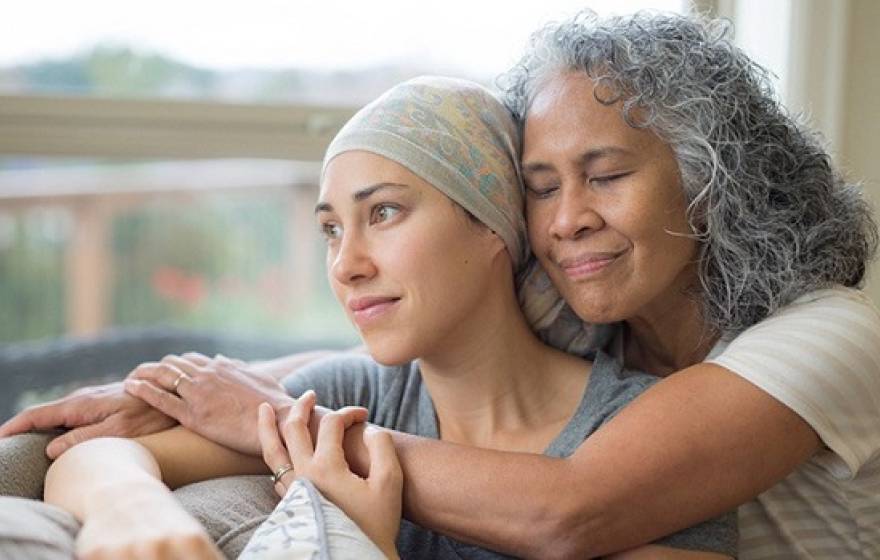 A woman holds her friend