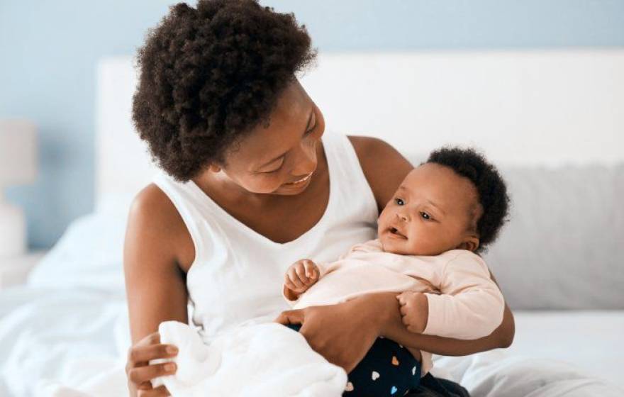 Black mother holding her baby