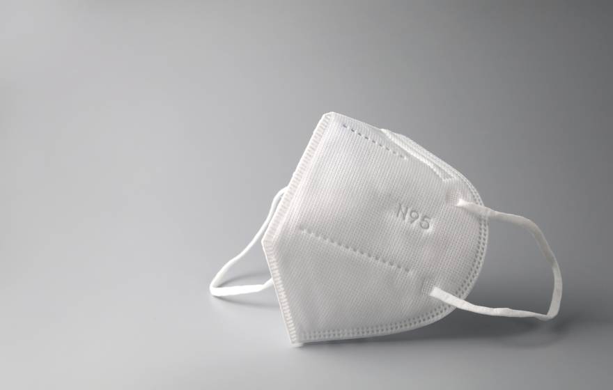N95 mask on grey background