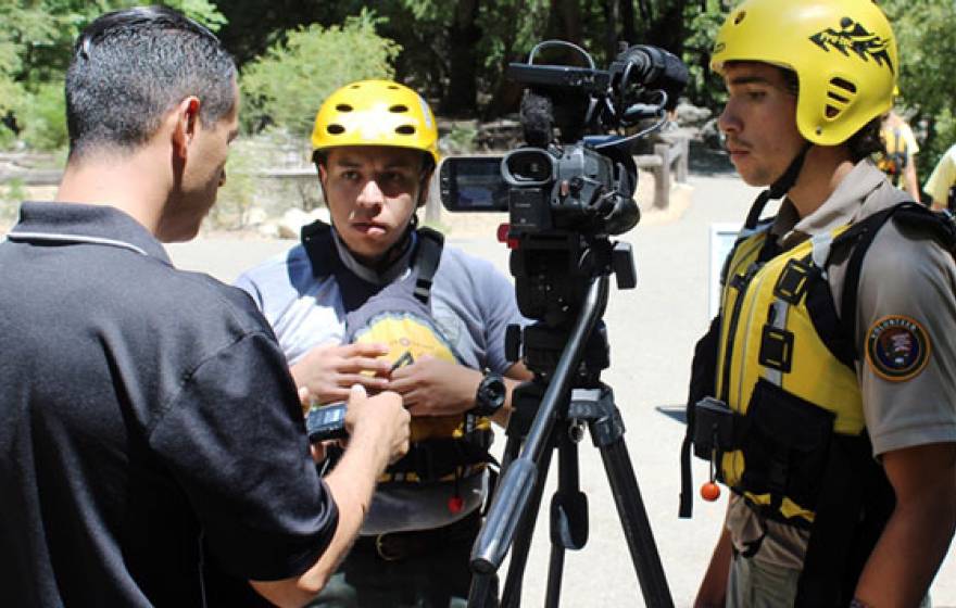 Vets gathered around a video camera