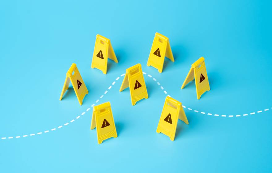 A set of childlike yellow construction warning signs with little warning signs on them with a dotted line going through, on a light blue background