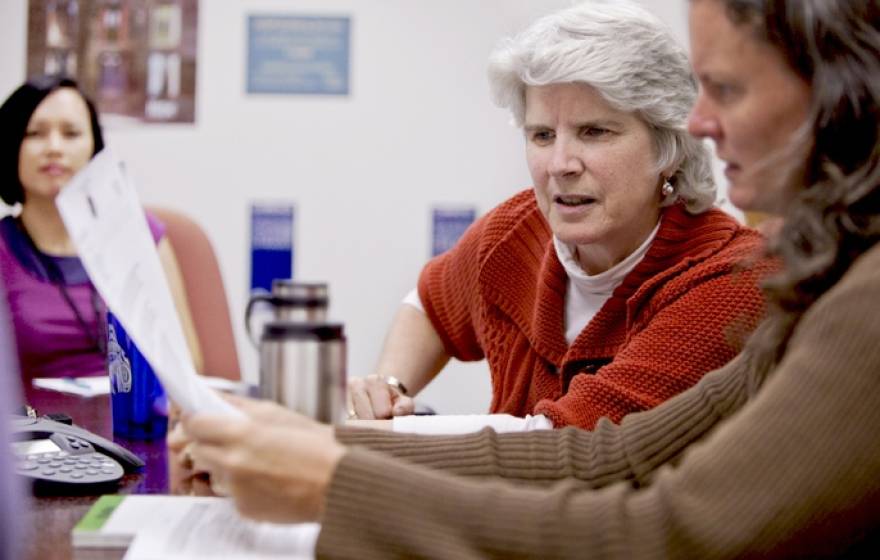 staff discussing a document