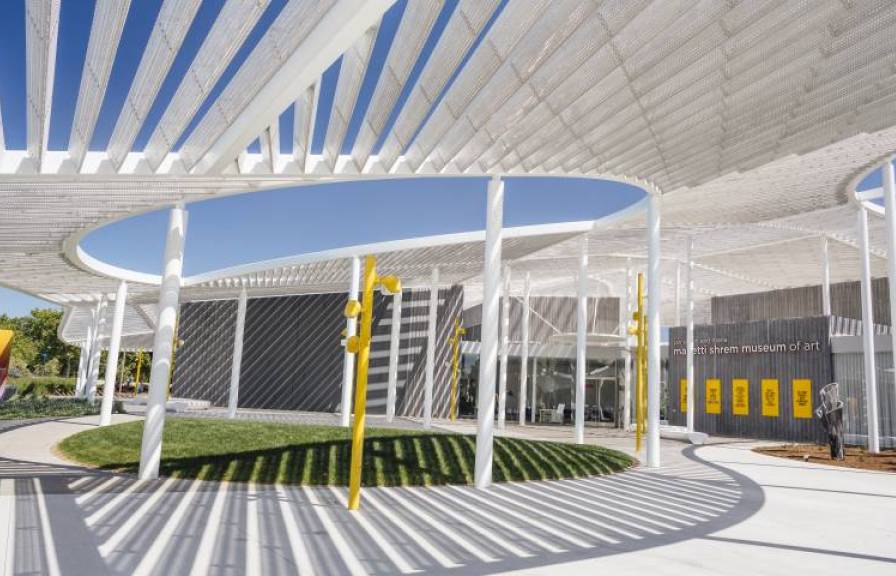 White and yellow modern building and walkway at the UC Davis campus. 