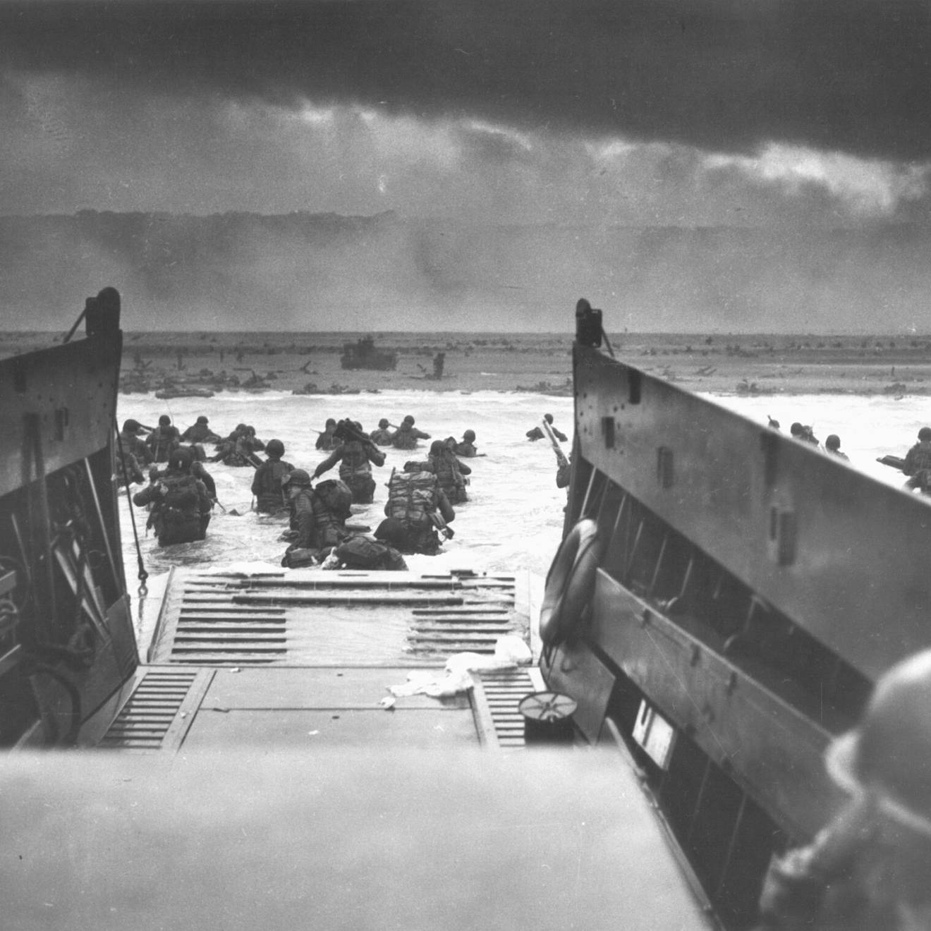 Photographed from inside a landing vessel, the U.S. Army wades ashore on D-Day, June 6, 1944