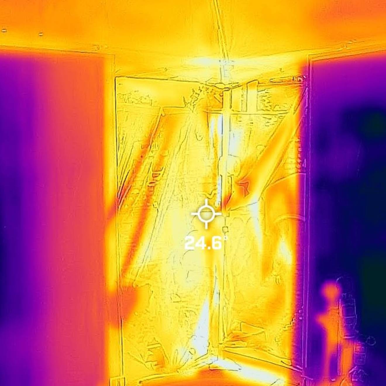 A thermal image with patches of bright yellow, orange, and purple