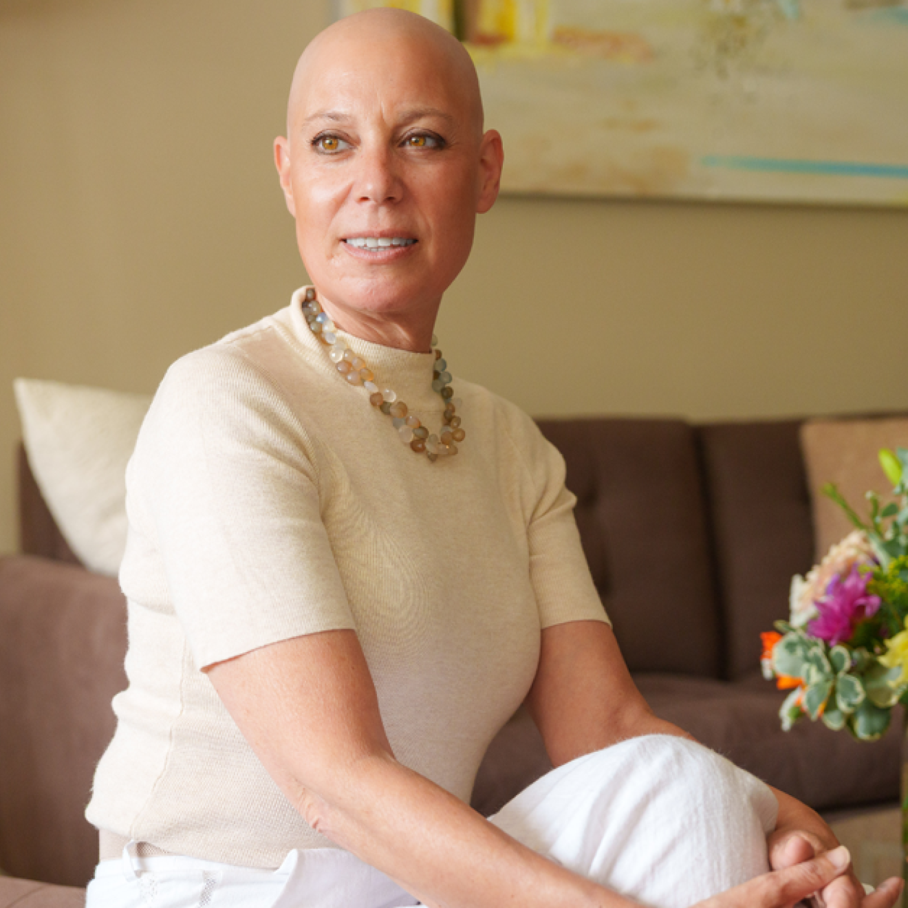Well-dressed woman without hair on her head from chemotherapy looks into the distance